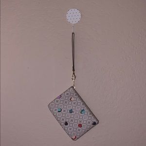 Small signature with heart print Fossil Clutch.